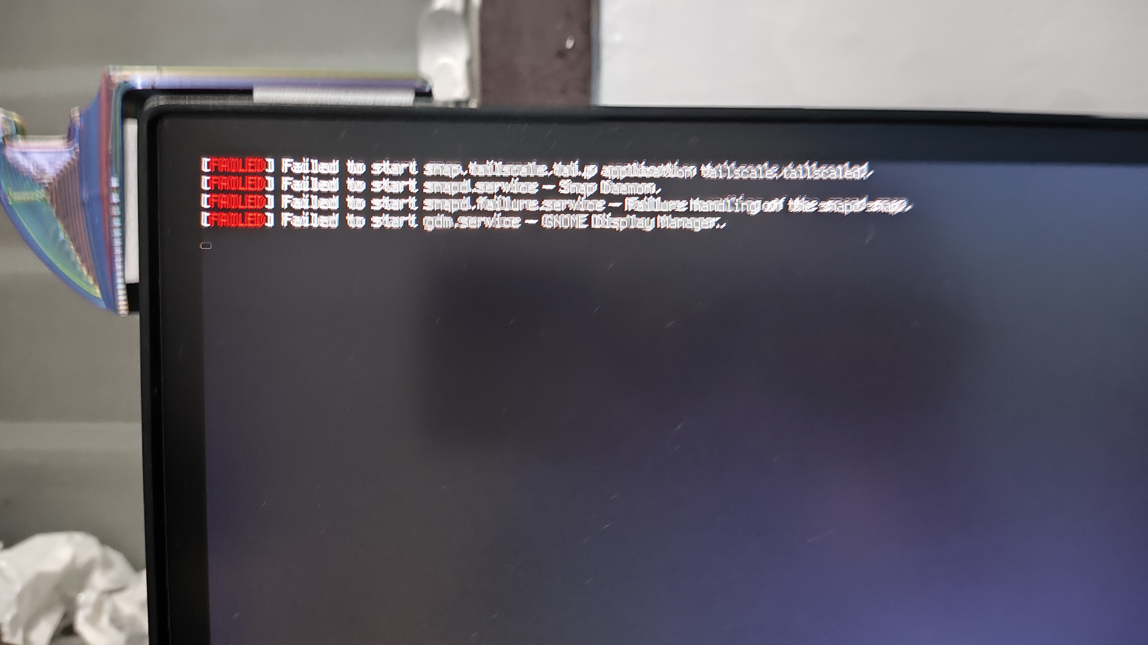 A homelab monitor displaying a wall of red systemd service-failed messages — the day the boxes collectively gave up.