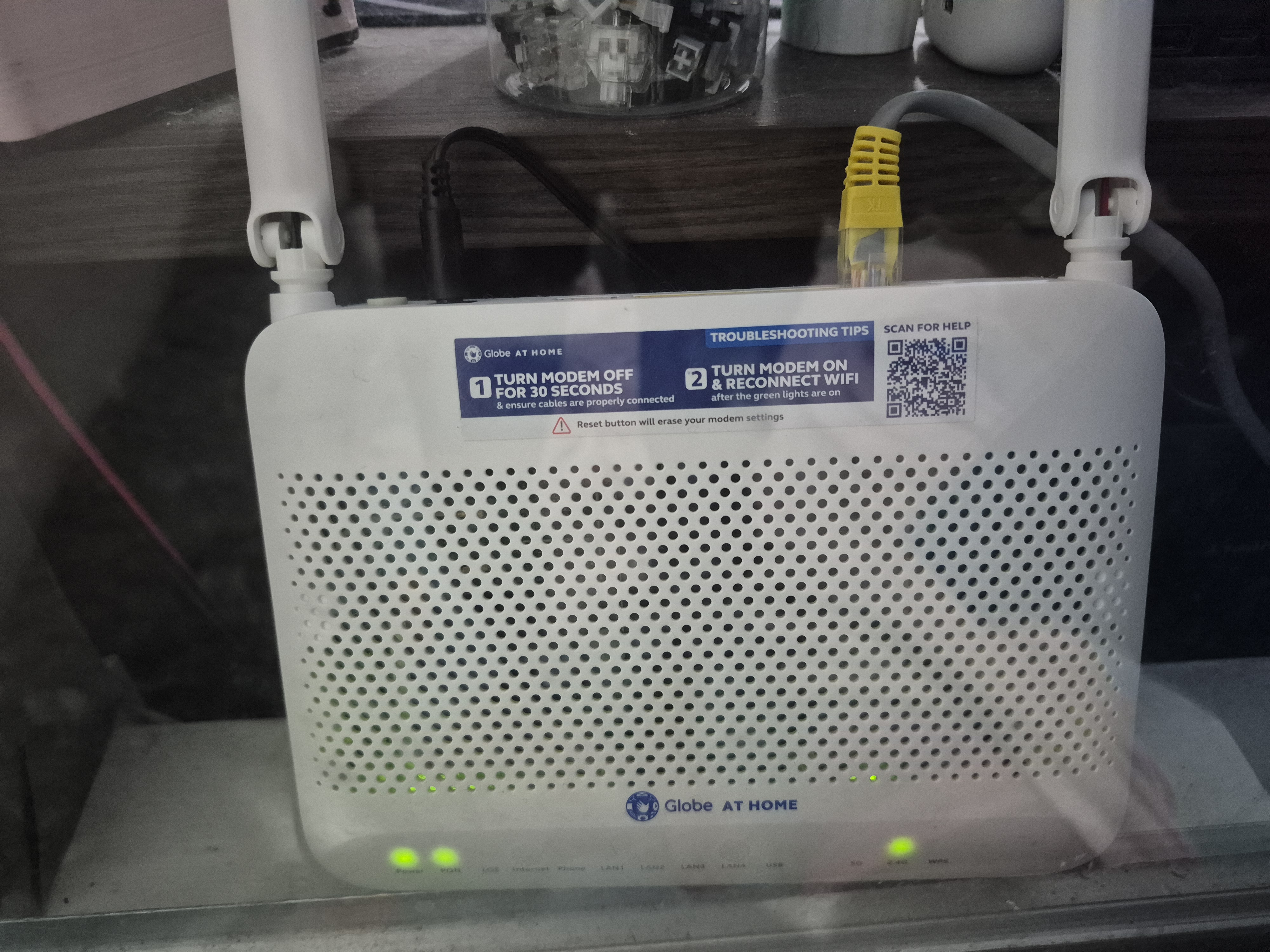 A stock Globe at Home ISP router with a troubleshooting sticker — the edge of the network before the real homelab starts.