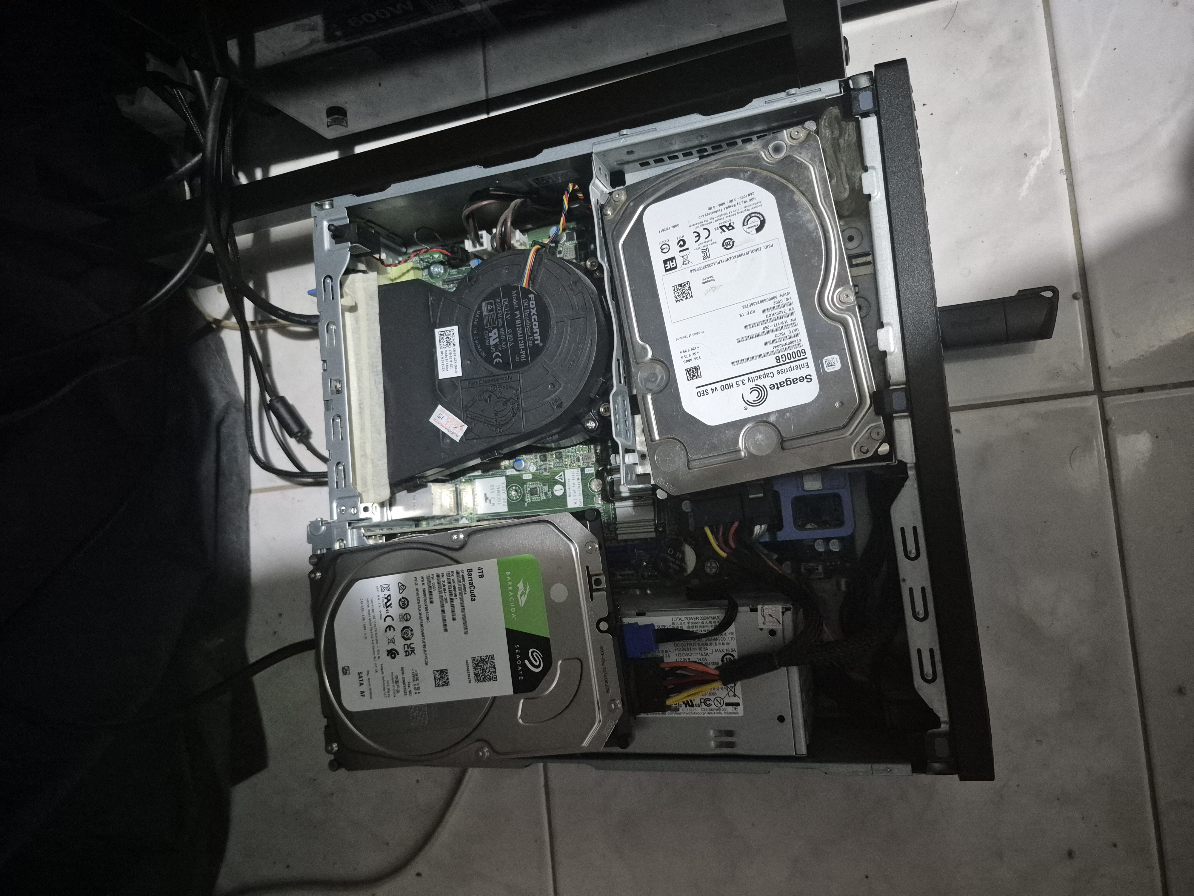 Inside a mini PC chassis: two Seagate drives (a 4 TB BarraCuda and a 6 TB Enterprise) seated where an optical drive used to be.